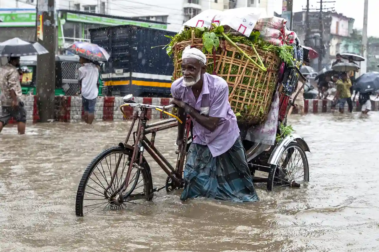 Falta financiación para adaptación al cambio climático en los países en desarrollo. Un hombre camina a través de aguas inundadas y fuertes lluvias, en Chittagong, Bangladesh / Foto: EP