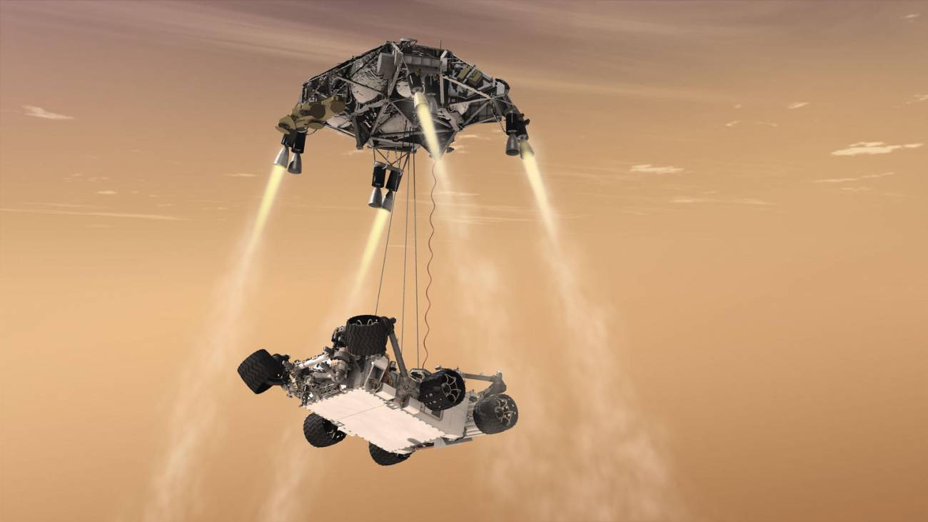 Recreación del sistema de grúas (skycrane) depositando el rover en el suelo marciano / NASA
