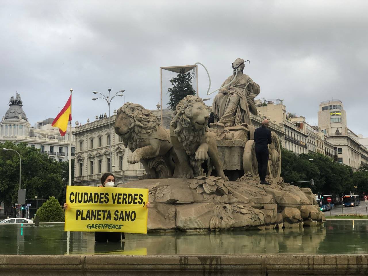 Activistas de Greenpeace colocan una mascarilla a la Cibeles / Foto:  Greenpeace